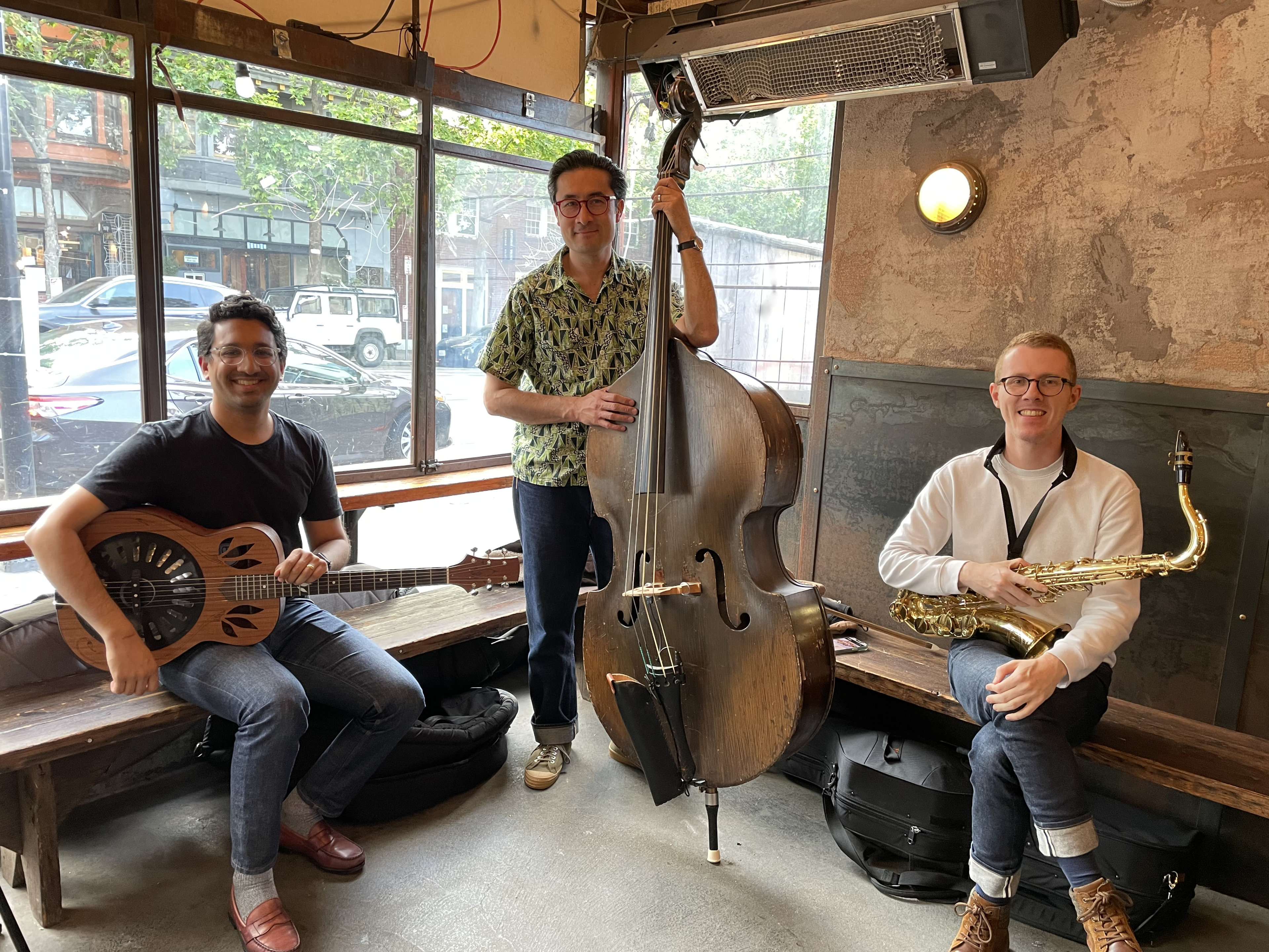 Three musicians about to perform in a backyard